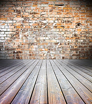 Old interior with colored brick wall and wooden floor