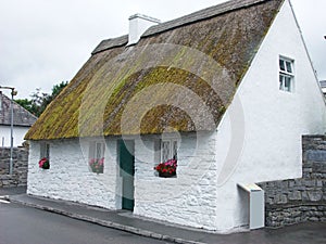 Old Irish Thatch Cottage in a village in Ireland photo