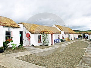 Old Irish Thatch Cottage in a village in Ireland photo