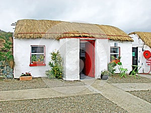 Old Irish Thatch Cottage in a village in Ireland photo