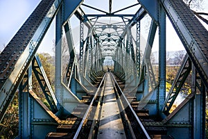 Old iron bridge with railway tracks