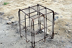 Old iron cage on the ground on the grounds in the construction site