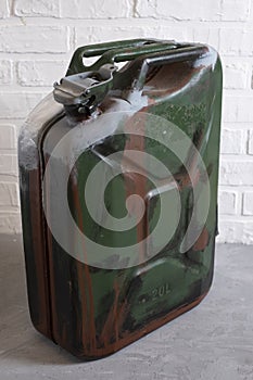 Old iron canister for gasoline or diesel fuel 20 liters on light background
