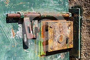 Old iron door lock and hasp on a metal door