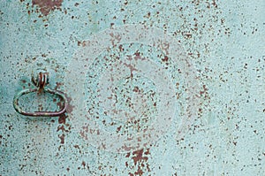 Old iron fence. Old cracked paint. Vintage fence. Rusty metal. Rust structure. Old vintage door handle. Padlock. Iron gate.