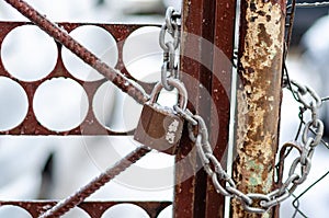 The old iron gate is locked with a chain. Breaking and entering private property. Closed Secret Zone