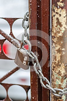 The old iron gate is locked with a chain. Breaking and entering private property. Closed Secret Zone