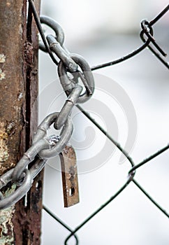 The old iron gate is locked with a chain. Breaking and entering private property. Closed Secret Zone