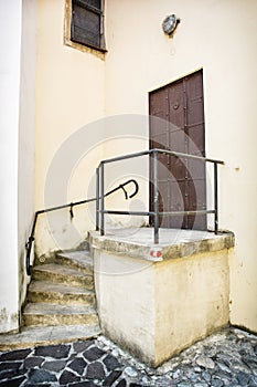 Old iron gate with railing and staircase to the church