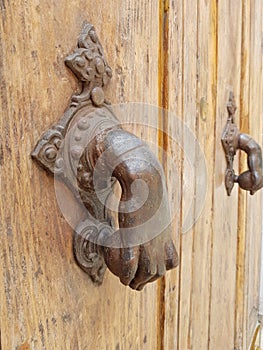 Antique iron handle on a wooden door