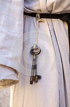 old iron key hanging on a belt, medieval reenactment