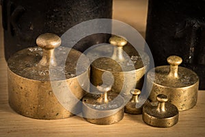 Old iron 1kg weight and smaller brass weights for a kitchen scale photo