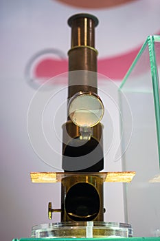 Old iron microscope with magnifying lenses