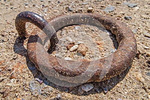 Old iron mooring cleat on a concrete pier