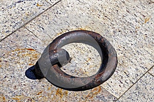 Old iron mooring ring on a stone dock, Rio
