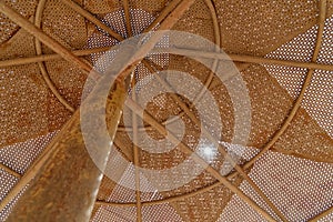 An old iron parasol at the beach of Aqaba, Jordan, abstractly cut and taken as a detail from below