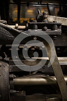 Old iron parts on the rods and driving wheels of a steam engine