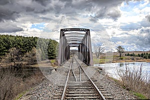 An Old iron railway truss bridge crossing the Mississippi river in spring in Galetta, Ontario, Canada