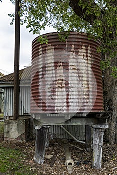 Old Iron Tank Stand On Wooden Posts