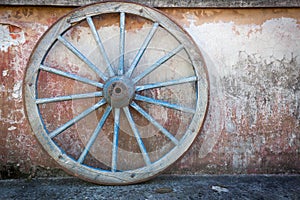 Old ironed, blue wagon or carriage wheel