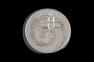 An old Israeli shekel coin on a black background
