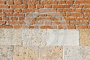 Old italian brick and bright stone wall after an architectural restoration Italy-Tuscany region