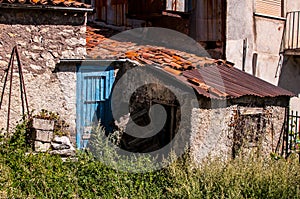 Old italian house in disrepair with blue door