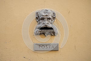 Old Italian mail slot with text Posta in old wall photo