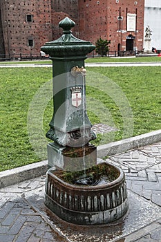 Old Italian outdoor water tap in the castle of Sforza,