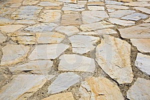 Old italian paving built with irregularly shaped stone blocks called opus incertum