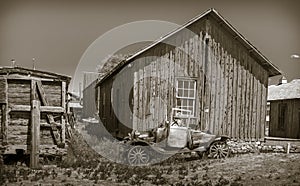 Old jalopy in front of a wooden shed