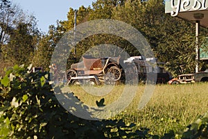 Old jalopy on a trailer in a grassy field