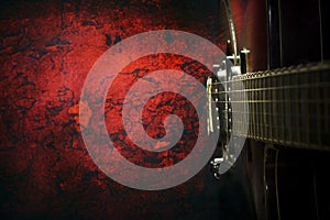 Old, jazz electric guitar on a red grunge background. Copy space. Top view Background for music festivals, concerts. Musical