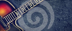 Old jazz electro guitar on a dark background. Close up. Copy space. Background for music festivals, concerts. Music background