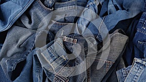 Old jeans. Blue cotton denim jeans. Quickly changing fashions, clothing waste