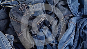 Old jeans. Blue cotton denim jeans. Quickly changing fashions, clothing waste