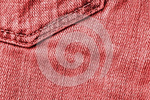 Old jeans texture close up, top view. Denim background, red color toned