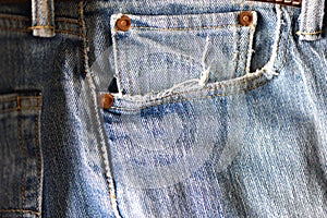 Old jeans. Tousled thread on the pocket of jeans. Shabby stuff.