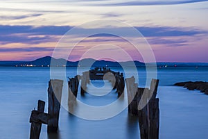 Old jetty with mountains backdrop