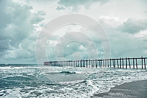 Old jetty over the stormy sea