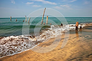 Old jetty pillars in sea