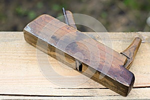 Old jointer on wooden background, carpentry tool