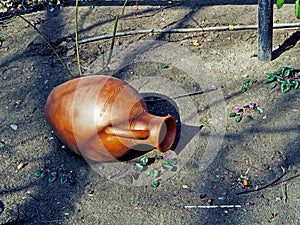 Old jug on the ground in the yard of a roadside restaurant