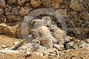 Old jug near stone wall, archaeological park of Shiloh, Israel