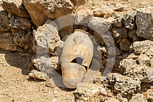 Old jug near stone wall, archaeological park of Shiloh, Israel