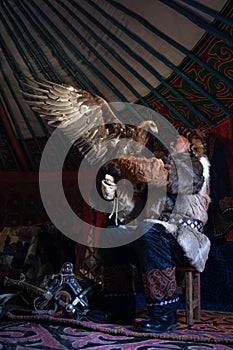 Old kazakh eagle hunter with his golden eagle