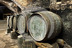 Old Keg Barrels in Row in Old Wine Cellar