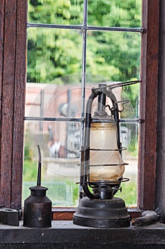 Old kerosene lamp on a window sill