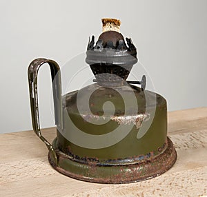 Old kerosene lamp on a wooden board.