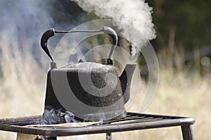 Old kettle boiling outdoors